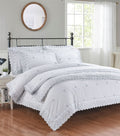 A beautifully crafted Gabrielle Bedspread featuring intricate floral embroidery and delicate lace trim, adding timeless elegance and sophisticated charm to a serene bedroom setting